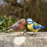 Two felted birds, a robin and a blue tit. Both have been created using craft kits by the Makerss.
