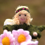 A close up of a felted Daisy flower fairy's face. The fairy has been made using The Makerss Official Flower Fairies Daisy Fairy Needle Felt Kit.