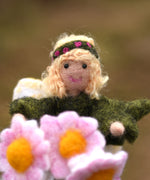 A close up of a felted Daisy flower fairy's face. The fairy has been made using The Makerss Official Flower Fairies Daisy Fairy Needle Felt Kit.