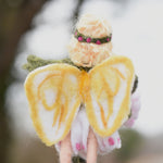 A close up of a felted Daisy flower fairy's wings showing the yellow coloured detailing on the white wings. The fairy has been made using The Makerss Official Flower Fairies Daisy Fairy Needle Felt Kit.