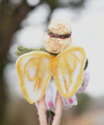 A close up of a felted Daisy flower fairy's wings showing the yellow coloured detailing on the white wings. The fairy has been made using The Makerss Official Flower Fairies Daisy Fairy Needle Felt Kit.
