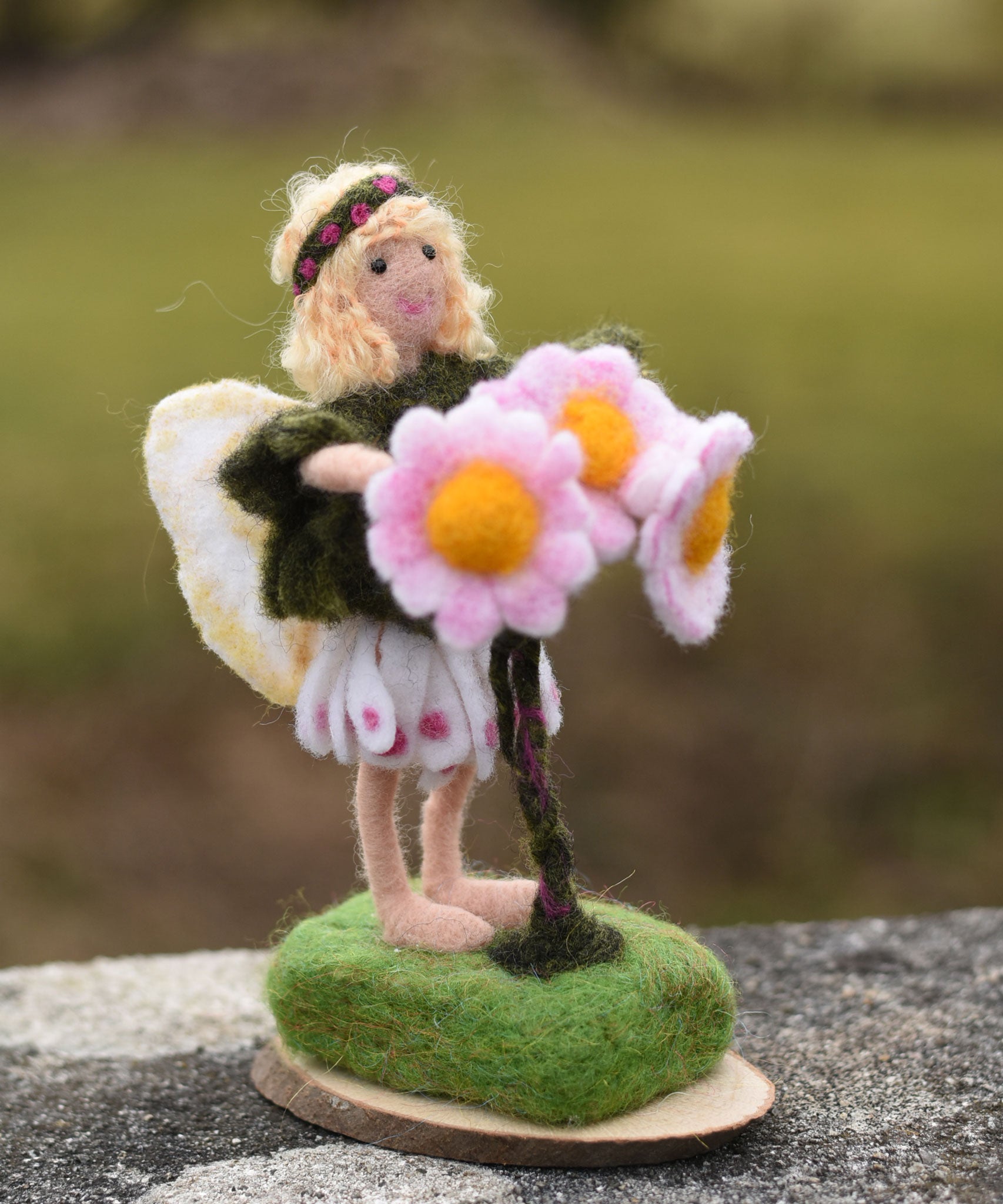 A Daisy flower fairy made using The Makerss Official Flower Fairies Daisy Fairy Needle Felt Kit.