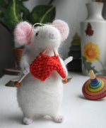 A felt figure of a mouse nitting made using the Makerss Small Knitting Mouse Needle Felt Kit.