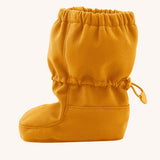 Side image of the Mamalila toddler allrounder winter booties in the mustard yellow colour available at Babipur showing the elasticated ankle cuff detail