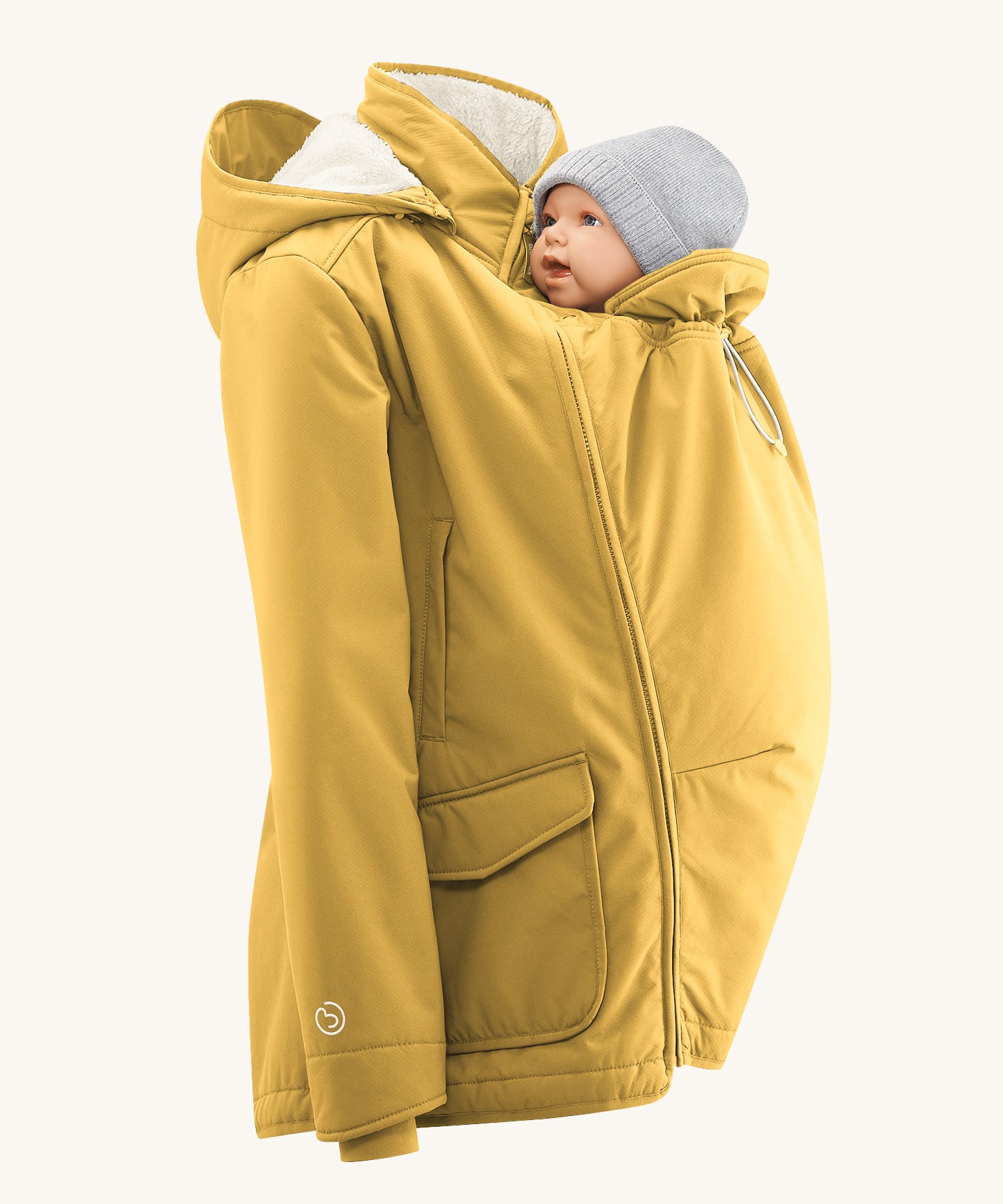 Mamalila Allweather Cosy Allrounder Babywearing Jacket in a Mustard yellow colour. The jacket is shown with the babywearing insert and a doll.
