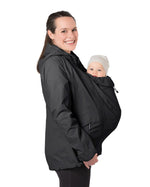 A person wearing the Mamalila Outdoor Explorer Babywearing Jacket - Black