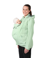  with their hands on their stomach over the top of the coat