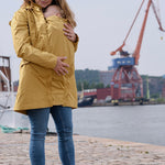 Mamalila Dublin Babywearing Rain Coat in Mustard. A sustainably made babywearing rain coat in mustard yellow. Side view