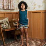 Child wearing the Maxomorra kids GOTS organic cotton boxer shorts in a blue, white, yellow and brown striped design with a blue vest top.