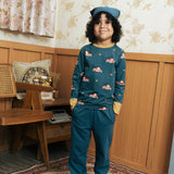 Child wearing the Maxomorra kids baggy sweat pants in navy, features a drawstring cord around the waist and side pockets with fire truck print long sleeved top.