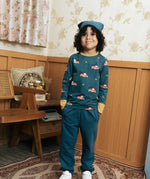 Child wearing the Maxomorra kids baggy sweat pants in navy, features a drawstring cord around the waist and side pockets with fire truck print long sleeved top.