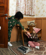 Two children wearing Maxomorra organic cotton clothing. one wearing green fox print long sleeve top one wearing the brown apple print top with ink trousers. 
