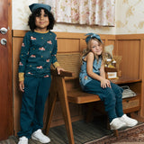 Two children wearing the Maxomorra kids baggy sweat pants in navy, features a drawstring cord around the waist and side pockets. One has a fire truck print top and one had an owl print vest top.