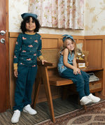 Two children wearing the Maxomorra kids baggy sweat pants in navy, features a drawstring cord around the waist and side pockets. One has a fire truck print top and one had an owl print vest top.