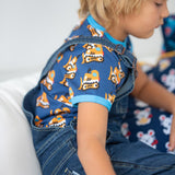 Close up of boy wearing the Maxomorra bulldozer short sleeve top under the navy denim dungarees