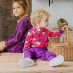 A baby wearing the Maxomorra Fairy print long sleeve bodysuit with a matching bib.  