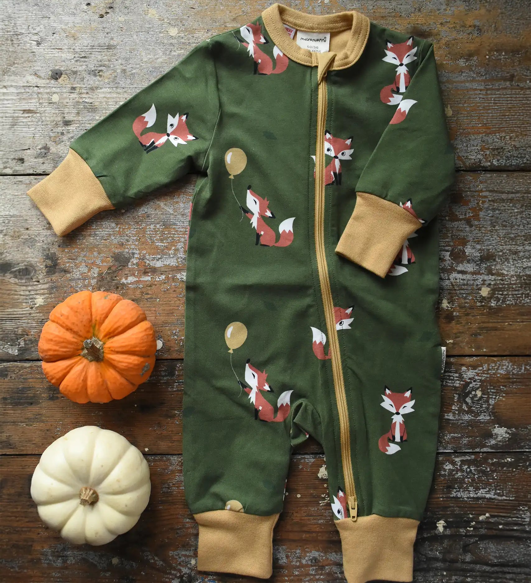 Maxomorra Fox Organic Cotton zip up Babygrow placed on a wooden surface with munchkin pumpkin placed next to it.