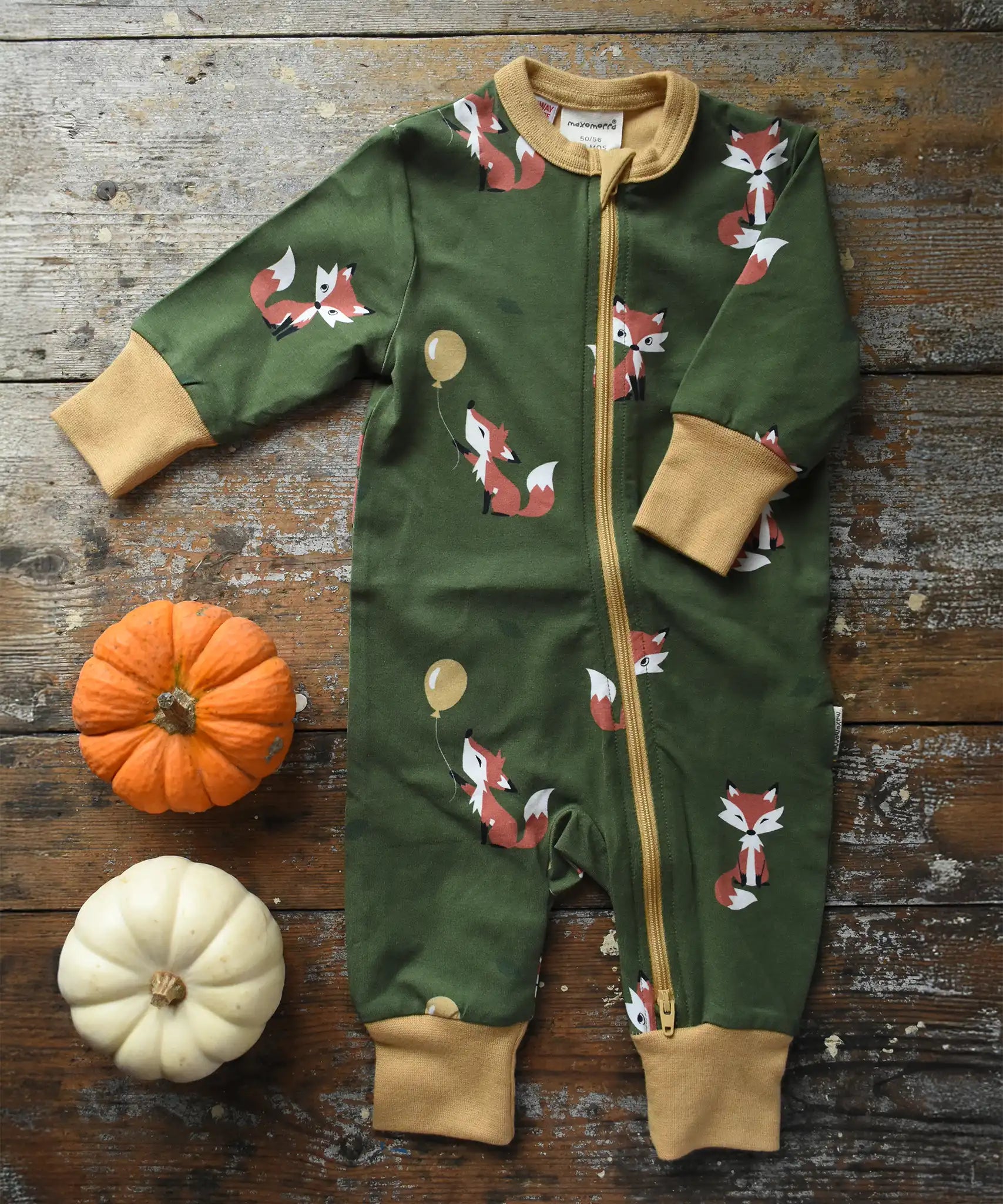Maxomorra Fox Organic Cotton zip up Babygrow placed on a wooden surface with munchkin pumpkin placed next to it.