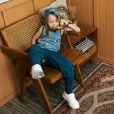 Child wearing the Maxomorra GOTS organic cotton kids tank vest top in blue with a cute repeating owl print and brown trim.with blue trousers.