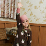 Child wearing the Maxomorra GOTS organic cotton long sleeve top in brown with a cute repeating pink apple print and pale pink neck line and cuffs with pink  beanie style hat.