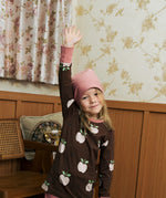 Child wearing the Maxomorra GOTS organic cotton long sleeve top in brown with a cute repeating pink apple print and pale pink neck line and cuffs with pink  beanie style hat.