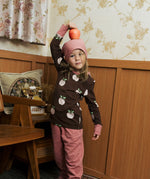 Child wearing the Maxomorra GOTS organic cotton long sleeve top in brown with a cute repeating pink apple print and pale pink neck line and cuffs with pink trousers and beanie style hat.