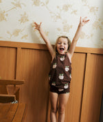 Girl wearing the Maxomorra's  GOTS organic cotton kids tank top in brown with a cute repeating pink apple print with matching trim with matching printpants.