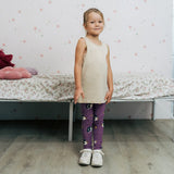 Girl wearing the Maxomorra kids GOTS organic cotton leggings in purple with a repeating cute hedgehog print and elasticated waist band with a cream vest top.