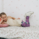 Girl wearing the Maxomorra kids GOTS organic cotton leggings in purple with a repeating cute hedgehog print and elasticated waist band with a cream vest top.
