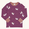 Maxomorra kids unicorns organic cotton long sleeve top. Purple top with  repeat unicorn print and light pink arm cuffs and binding on the neck. 
