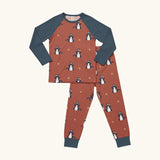 Maxomorra kids organic cotton long sleeved top and trousers pyjama set with dragon print. Red background with blue dragons with yellow fire outlines. The top has blue block colour arms and neck trim, the trousers have blue leg cuffs.