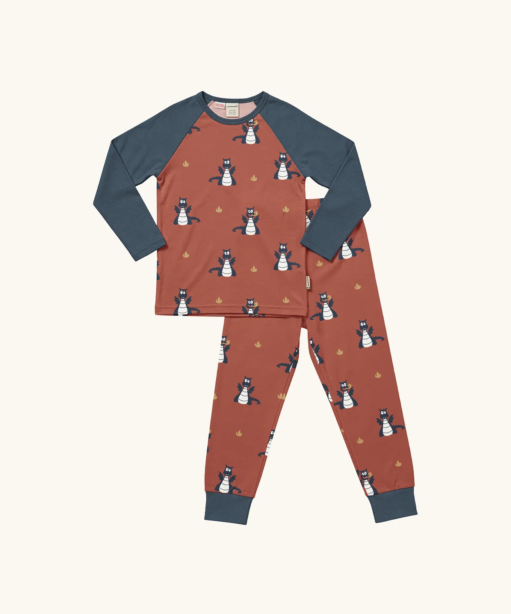 Maxomorra kids organic cotton long sleeved top and trousers pyjama set with dragon print. Red background with blue dragons with yellow fire outlines. The top has blue block colour arms and neck trim, the trousers have blue leg cuffs.