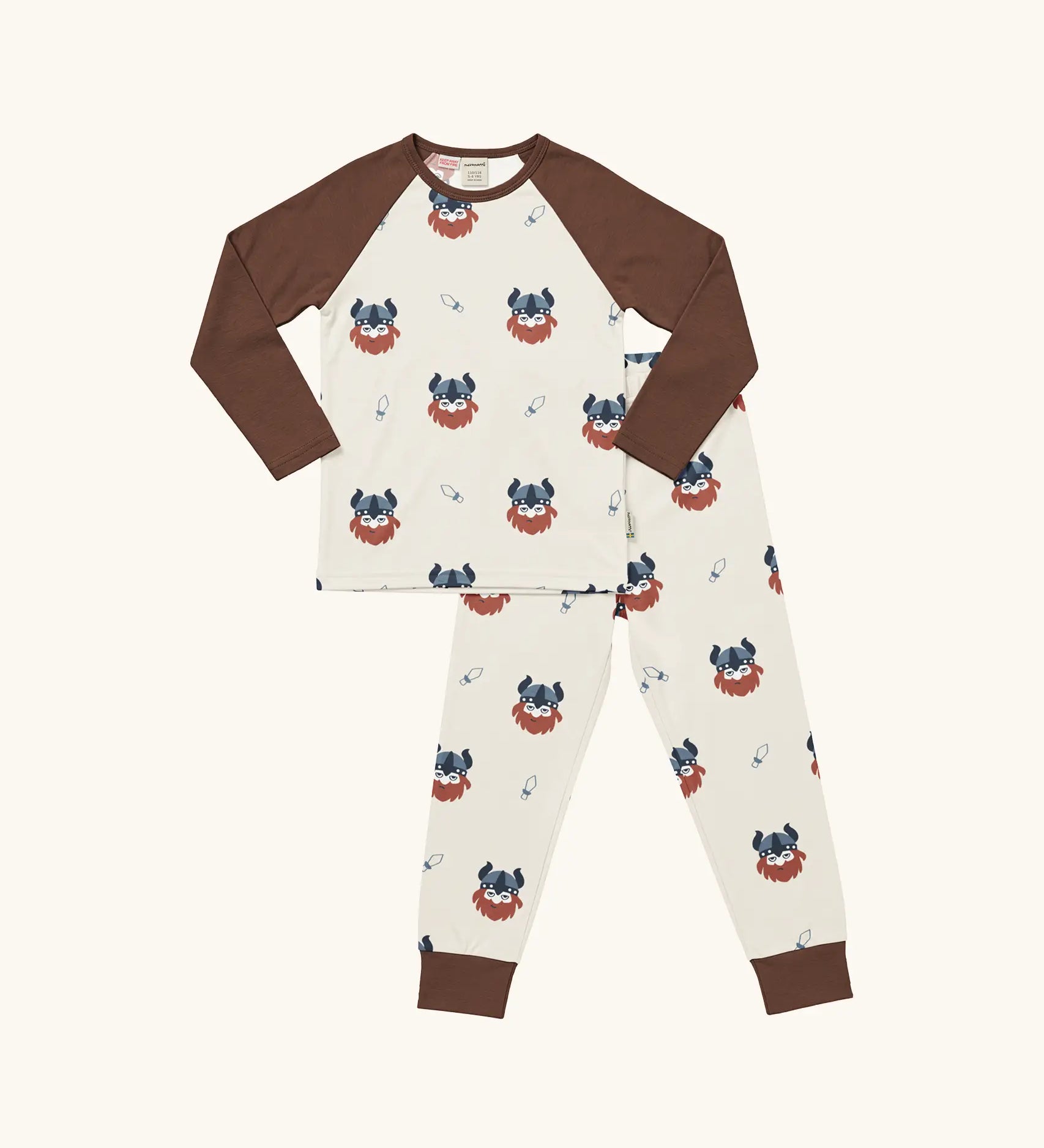 Maxomorra kids organic cotton long sleeved top and trousers pyjama set with vikings print. Light cream background with bearded viking wearing a hat and blue dagger sword outlines. The top has brown block colour arms and neck trim, the trousers have brown leg cuffs.