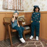 Two children wearing the Maxomorra kids baggy sweat pants in navy, features a drawstring cord around the waist and side pockets. One has a fire truck print top and one had an owl print vest top.