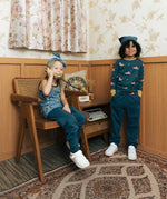 Two children wearing the Maxomorra kids baggy sweat pants in navy, features a drawstring cord around the waist and side pockets. One has a fire truck print top and one had an owl print vest top.