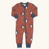 Maxomorra organic cotton zipped babygrow with dragon print. Red background with repeat print featuring blue dragons with yellow fire outlines and blue arm cuffs, binding on the neck and zip. 