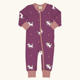 Maxomorra organic cotton zipped babygrow with unicorns. Purple background with repeat print featuring unicorns with multi coloured manes and yellow stars with pink arm cuffs, binding on the neck and zip.