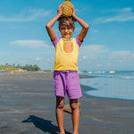 A child playing on a beach with their friends