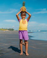 A child playing on a beach with their friends