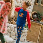 A child wearing the Maxomorra Reindeer Leggings with a coordinating reindeer print raglan top. 