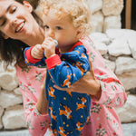 A young child wearing the Maxomorra Reindeer Long Sleeve Rompersuit.