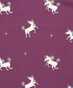 Maxomorra unicorns print on organic cotton. Purple background with all over repeat print featuring unicorns with multicoloured manes and yellow sparkles. 
