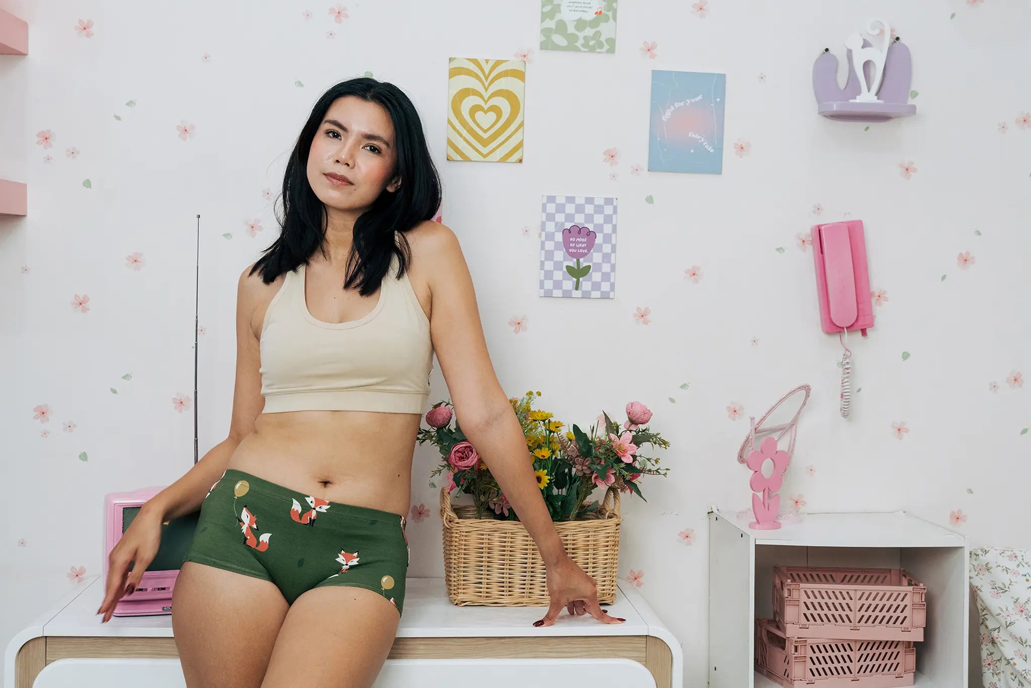 Woman wearing the Maxomorra GOTS organic cotton women's brief hipster pants in green with a repeating cartoon fox print with cream comfort bra top.