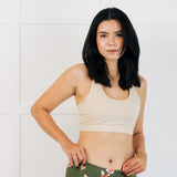 Woman wearing the Maxomorra GOTS organic cotton women's brief hipster pants in green with a repeating cartoon fox print with cream comfort bra top.