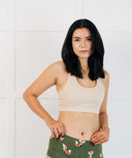 Woman wearing the Maxomorra GOTS organic cotton women's brief hipster pants in green with a repeating cartoon fox print with cream comfort bra top.