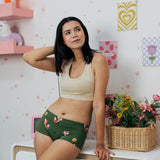 Woman wearing the Maxomorra GOTS organic cotton women's brief hipster pants in green with a repeating cartoon fox print with cream bra top.