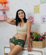 Woman wearing the Maxomorra GOTS organic cotton women's brief hipster pants in green with a repeating cartoon fox print with cream bra top.