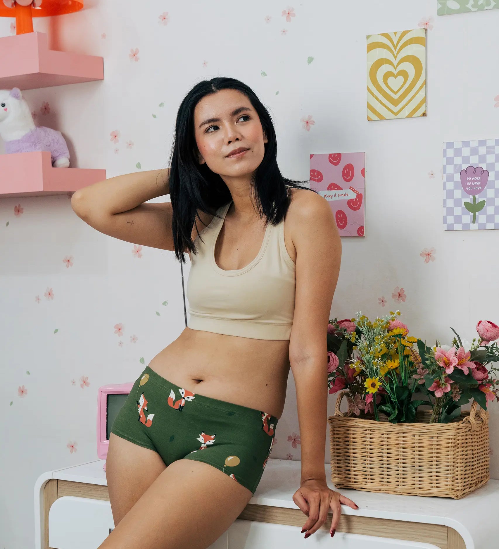 Woman wearing the Maxomorra GOTS organic cotton women's brief hipster pants in green with a repeating cartoon fox print with cream bra top.