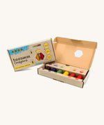 An open box of Medenka junior beeswax crayons, with six brightly coloured, thick crayons.
