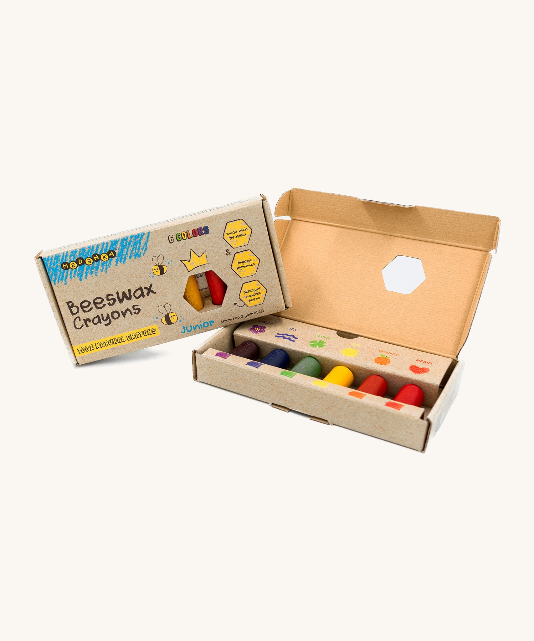 An open box of Medenka junior beeswax crayons, with six brightly coloured, thick crayons.